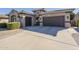 Spanish style home with a 3 car garage and manicured landscaping at 14113 W Windsor Ave, Goodyear, AZ 85395