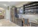 Built-in kitchen desk with granite countertop and dark wood cabinets at 14113 W Windsor Ave, Goodyear, AZ 85395