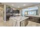 Modern kitchen island with white quartz countertop and dark cabinetry at 14113 W Windsor Ave, Goodyear, AZ 85395