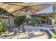 Relaxing patio with umbrella and seating for two at 14113 W Windsor Ave, Goodyear, AZ 85395