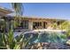 Stunning pool with a spacious patio and lush landscaping at 14113 W Windsor Ave, Goodyear, AZ 85395