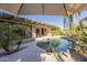 Resort-style pool and spa with a covered patio and lush landscaping at 14113 W Windsor Ave, Goodyear, AZ 85395