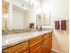 Bathroom with granite countertops and wood cabinets at 14950 W Mountain View Blvd # 2301, Surprise, AZ 85374