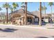 Attractive community entrance with palm trees and fountain at 14950 W Mountain View Blvd # 2301, Surprise, AZ 85374