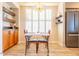 Small dining area with a table and chairs, located near a window with white plantation shutters at 14950 W Mountain View Blvd # 2301, Surprise, AZ 85374