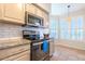 Kitchen features granite countertops, stainless steel appliances, and a view of the dining area at 14950 W Mountain View Blvd # 2301, Surprise, AZ 85374