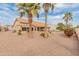 View of backyard with gravel, palm trees and home at 15225 W Via Manana Dr, Sun City West, AZ 85375