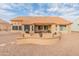 Sun-drenched backyard with patio, mature plants and gravel at 15225 W Via Manana Dr, Sun City West, AZ 85375