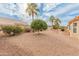 Landscaped backyard with gravel, mature trees, and a built-in BBQ area at 15225 W Via Manana Dr, Sun City West, AZ 85375