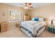 Bright bedroom with a ceiling fan, large window, and ample closet space at 15225 W Via Manana Dr, Sun City West, AZ 85375