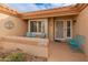 Inviting front entry with a decorative door, a small patio, and colorful seating at 15225 W Via Manana Dr, Sun City West, AZ 85375