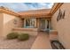 Inviting front entry with a decorative door, a small patio, and colorful seating at 15225 W Via Manana Dr, Sun City West, AZ 85375