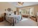 Main bedroom with large window and ceiling fan at 15225 W Via Manana Dr, Sun City West, AZ 85375