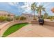 Spacious backyard patio with artificial turf and grill at 15225 W Via Manana Dr, Sun City West, AZ 85375