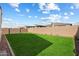 Landscaped backyard with large green lawn area at 16780 W Cameron Dr, Surprise, AZ 85388