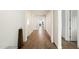 Long hallway with light wood flooring, leading to bedrooms at 16780 W Cameron Dr, Surprise, AZ 85388