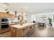 Modern kitchen with light wood cabinets, island, and stainless steel appliances at 16780 W Cameron Dr, Surprise, AZ 85388