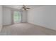 Spacious bedroom with carpeted floor, ceiling fan, and large window at 17251 N Del Webb Blvd, Sun City, AZ 85373