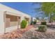 Side view of a light beige house with brown shutters, showing a walkway and landscaping at 17251 N Del Webb Blvd, Sun City, AZ 85373