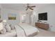 Main bedroom with dresser, large bed, and mounted television at 17251 N Del Webb Blvd, Sun City, AZ 85373