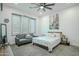 Bright bedroom with a queen-size bed and a gray couch at 18145 W Rancho Dr, Litchfield Park, AZ 85340