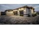 Dark gray three-car garage with stone accents at 18145 W Rancho Dr, Litchfield Park, AZ 85340