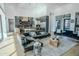 Open concept living room with a modern kitchen and black leather sectional at 18145 W Rancho Dr, Litchfield Park, AZ 85340