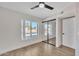 Well-lit bedroom with mirrored closet and ceiling fan at 1819 W Evans Dr, Phoenix, AZ 85023