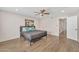 Spacious bedroom with ceiling fan and wood-look tile floors at 1819 W Evans Dr, Phoenix, AZ 85023