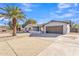 House exterior showcasing a two-car garage and palm tree at 1819 W Evans Dr, Phoenix, AZ 85023