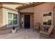 Courtyard entry with seating and a patterned floor at 19111 N 94Th Ave, Peoria, AZ 85382