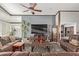 Spacious living room featuring leather furniture, a large TV, and a rustic coffee table at 19111 N 94Th Ave, Peoria, AZ 85382