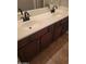 Bathroom with double sinks and dark wood cabinets at 20391 E Via Del Oro Dr, Queen Creek, AZ 85142