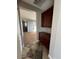 Hallway with tile floor and built-in wooden cabinets at 20391 E Via Del Oro Dr, Queen Creek, AZ 85142