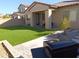 House exterior with artificial turf and grill at 20496 W Valley View Dr, Buckeye, AZ 85396