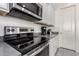 Modern kitchen featuring stainless steel appliances and gray countertops, creating a sleek, functional cooking space at 20496 W Valley View Dr, Buckeye, AZ 85396