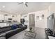 Open-concept living room and kitchen area, with a leather sectional, and modern stainless steel appliances at 20496 W Valley View Dr, Buckeye, AZ 85396