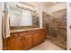 Bathroom with double sinks, granite countertop, and large shower at 22012 N Arrellaga Dr, Sun City West, AZ 85375