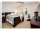 Spacious bedroom with dark wood furniture and neutral color scheme at 22012 N Arrellaga Dr, Sun City West, AZ 85375