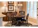 Charming dining area with wood table and chairs, chandelier, and window at 22012 N Arrellaga Dr, Sun City West, AZ 85375