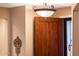 Interior entryway with wood door and elegant light fixture at 22012 N Arrellaga Dr, Sun City West, AZ 85375