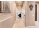 Long hallway with light walls and tile flooring at 22012 N Arrellaga Dr, Sun City West, AZ 85375