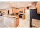 Eat-in kitchen with island, granite counters & stainless steel appliances at 22012 N Arrellaga Dr, Sun City West, AZ 85375