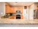 Spacious kitchen featuring wood cabinets and granite countertops at 22012 N Arrellaga Dr, Sun City West, AZ 85375