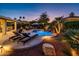 Lush pool area with a waterfall, lounge chairs, and a tranquil ambiance at 22012 N Arrellaga Dr, Sun City West, AZ 85375