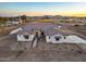 Aerial view of a craftsman style home with tile roof and landscaping at sunset at 22859 W Euclid Ave, Buckeye, AZ 85326