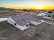 Aerial view of house at sunset with surrounding landscape at 22859 W Euclid Ave, Buckeye, AZ 85326