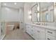 Modern bathroom with double vanity, a large mirror, and a tub shower combo at 22859 W Euclid Ave, Buckeye, AZ 85326