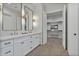 Modern bathroom with double vanity, large mirrors, and walk-in closet at 22859 W Euclid Ave, Buckeye, AZ 85326