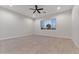 Bright bedroom with tile floors and a window with a view of trees at 22859 W Euclid Ave, Buckeye, AZ 85326